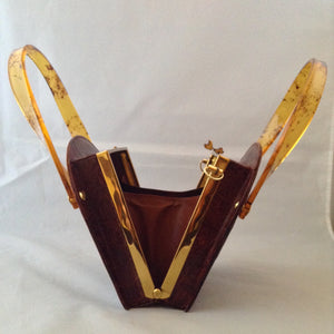 Vintage 1960s brown crocodile purse with lovely lucite handles. This unusual shape will stand out in a crowd. Hidden chain, if you love a shoulder bag.