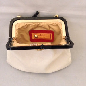 Vintage purse with supple vanilla leather which complements the bold browns and golds of the strolling elephants adorning it. A tortoise and golden chain handle and lucite frame are so classic, creamy and dreamy.   Dimensions - 6" Height; 8" Width; 15" Length with chain