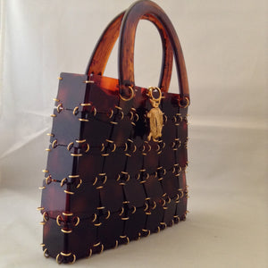 Vintage 1960's brown lucite and chain mail handbag set off with a vintage golden turtle clasp. So unique and so much fun!   Dimensions - 7" Height; 9" Width; 12" Length with handle