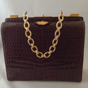 Vintage 1960s Nettie Rosenstein brown crocodile handbag with gold chain. 