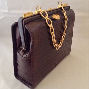 Vintage 1960s Nettie Rosenstein brown crocodile handbag with gold chain. 