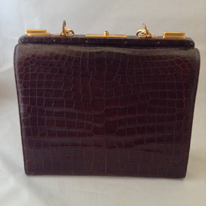 Vintage 1960s Nettie Rosenstein brown crocodile handbag with gold chain. 