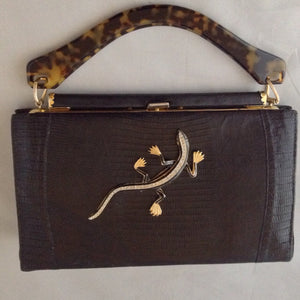 Black On Black Lizards. Classic black lizard vintage purse with perfect proportions sports a perfect black vintage lizard and a vintage lucite tortoise handle. Perfectly perfect for every occasion.   Dimensions - 7" Height; 10" Width; 9-1/2" Length with handles