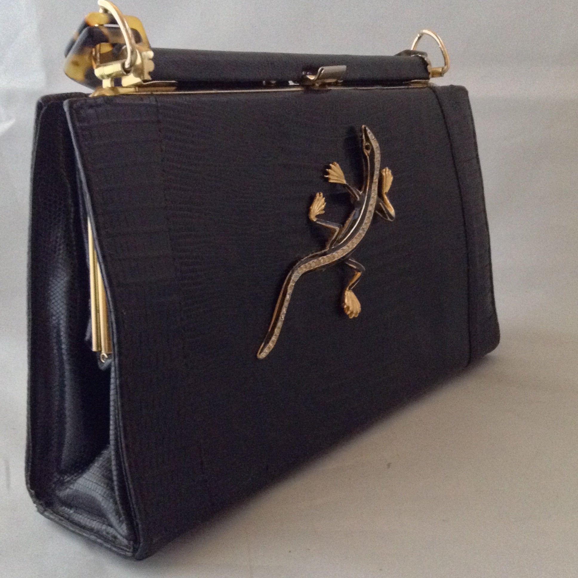 Black On Black Lizards. Classic black lizard vintage purse with perfect proportions sports a perfect black vintage lizard and a vintage lucite tortoise handle. Perfectly perfect for every occasion.   Dimensions - 7" Height; 10" Width; 9-1/2" Length with handles