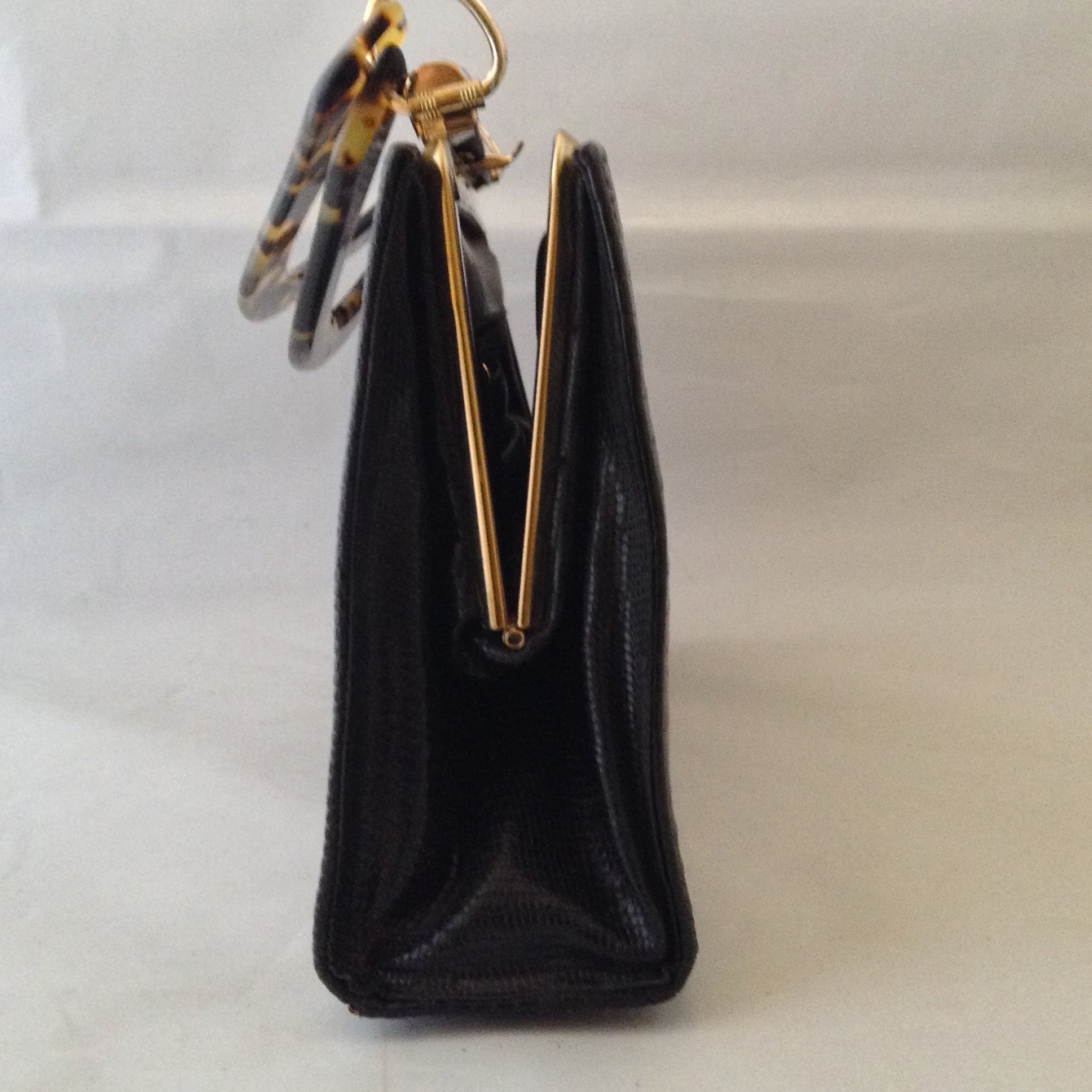 Black On Black Lizards. Classic black lizard vintage purse with perfect proportions sports a perfect black vintage lizard and a vintage lucite tortoise handle. Perfectly perfect for every occasion.   Dimensions - 7" Height; 10" Width; 9-1/2" Length with handles