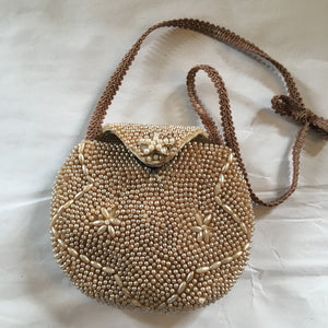 Charming micro-beaded little neutral purse with starfish closure and french trim that will please even the smallest wearers for her special event.  Dimensions - Height 3 1/3"; Width 4"; Handle 6"; Depth 1"