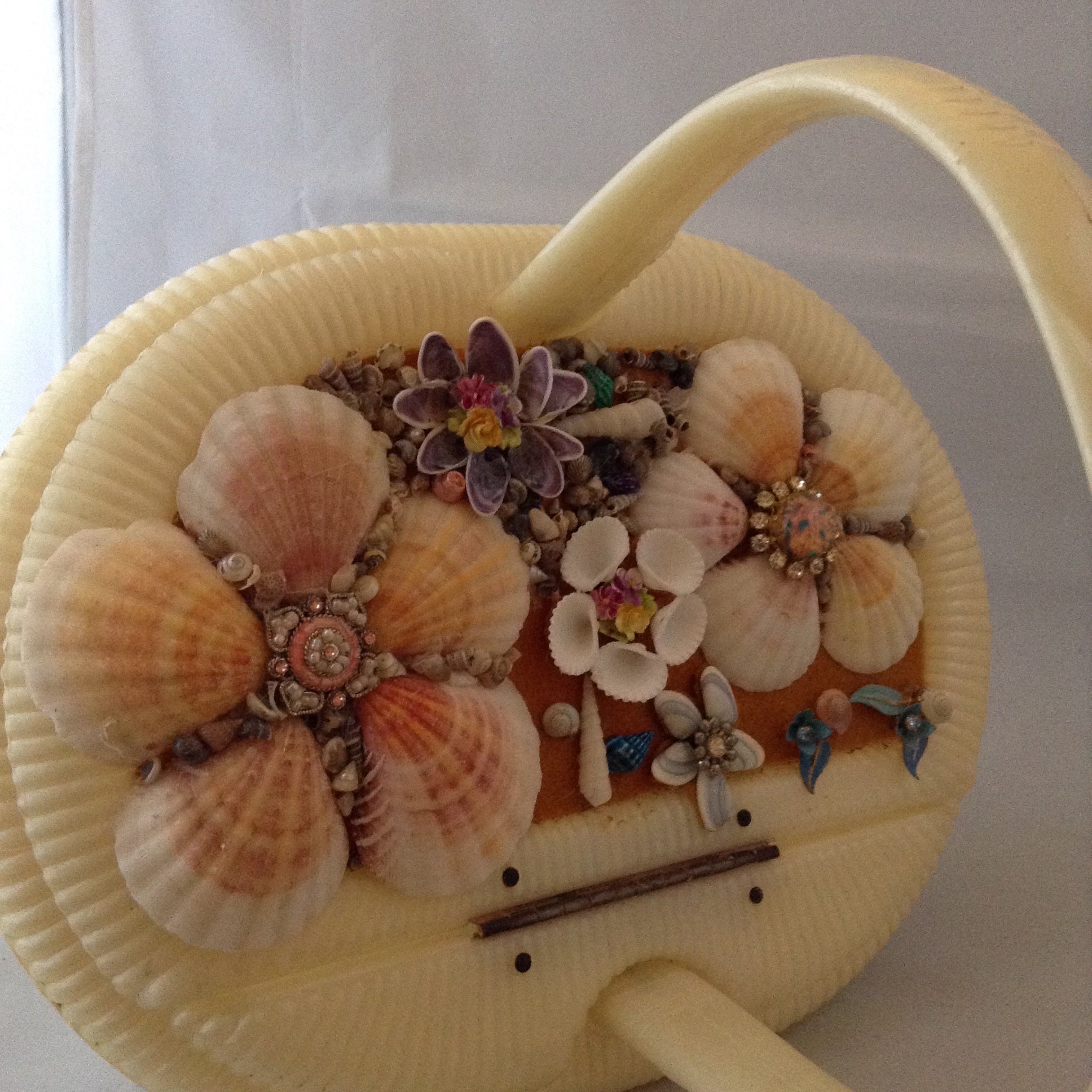 Vintage cream lucite basket purse with garden of seashells flowing the top. 