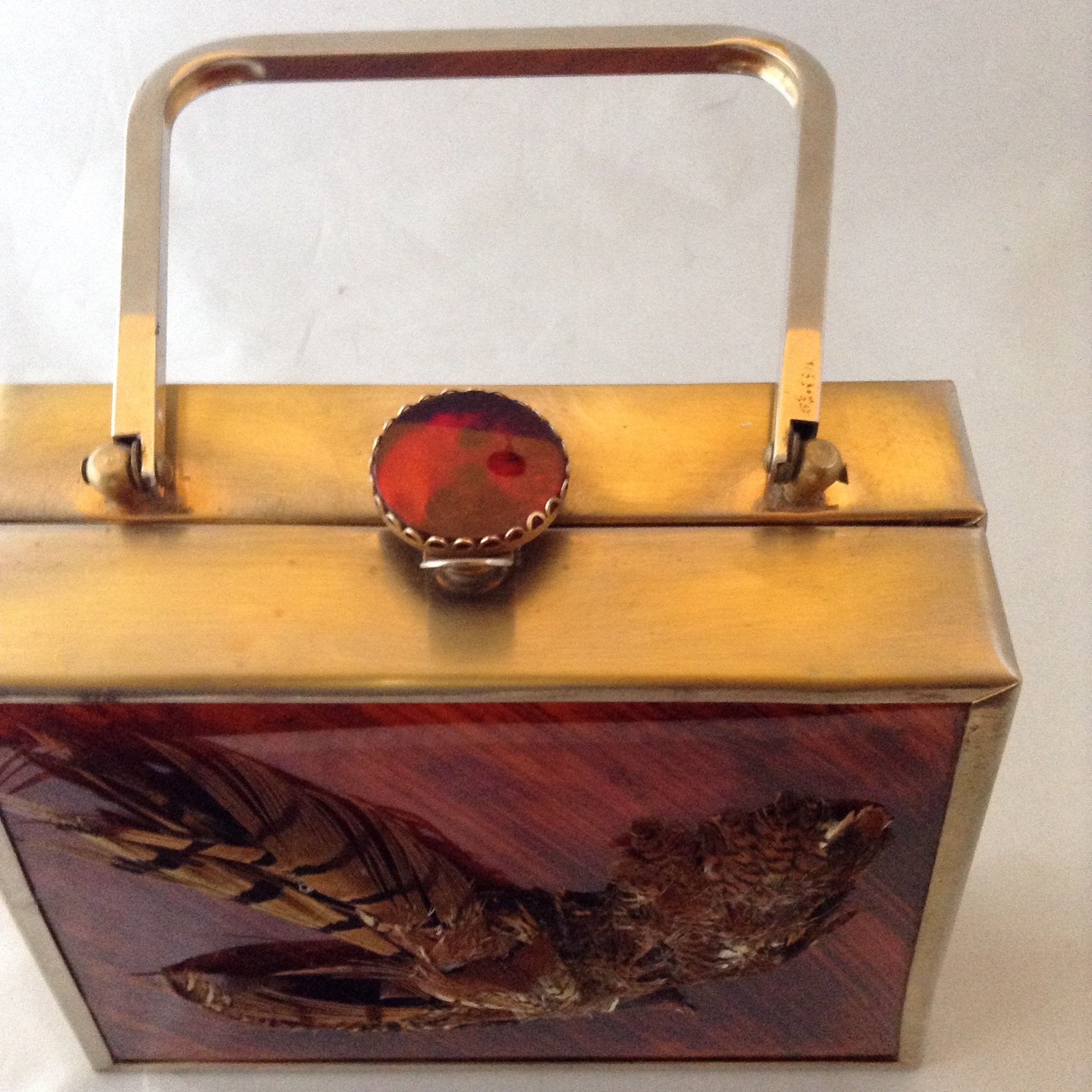 Vintage trapezoid cherry-wood colored lucite handbag with brass frame, vintage topaz colored brooch clasp and real pheasant feathers.