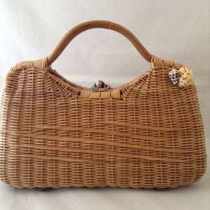 Lovely tan straw-grass purse made in Bali in the 1960s imagines a tropical sea bed with red silk lining. 1,014 shells, large and small, went into the making of this stunning piece. (Wanna count 'em?)  Dimensions - 8-1/2" Height; 13-1/2" Width"; 11 Length