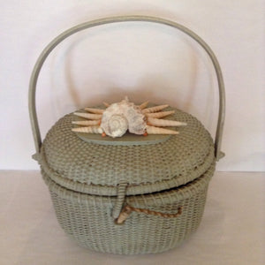 Ready for Nantucket, this pale green straw basket with unusual shell motif will travel with you all summer.  Dimensions - Height 8"; Width 9 1/2";  Length 11 1/2"; Depth 6"