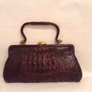 Ultimate brown crocodile purse with brass clasp and hardware dated from 1904. A timeless classic! Dimensions - Height 5"; Width 9"; Depth 2"; Handle 4"