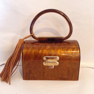 Little vintage lucite caramel 'lunchbox' purse. So delicious!  Vintage lucite from the 1940s with leather tassel. Gorgeous original brass hardware, new suede lining.