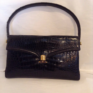 Vintage black crocodile purse made in Buenos Aires in the 60's by master craftsmen whose family business no longer exists. One of a kind, beautifully made, like new.