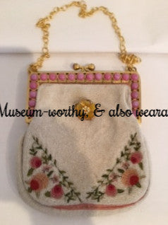 Micro-beading, hand-embroidered petit-point roses and lovely original hardware make this little Parisian 1940s bag a museum-quality treasure. The rose pink chalcedony stones are all original and in perfect condition, as is the exquisite hand-chased frame.  The original handle has been replaced with a beautiful vintage chain which detaches to wear as a necklace if you wish. Dimensions - 6" Height; 5" Width; 2" Depth. Chain 9" (Chain becomes an 18" necklace when detached.)