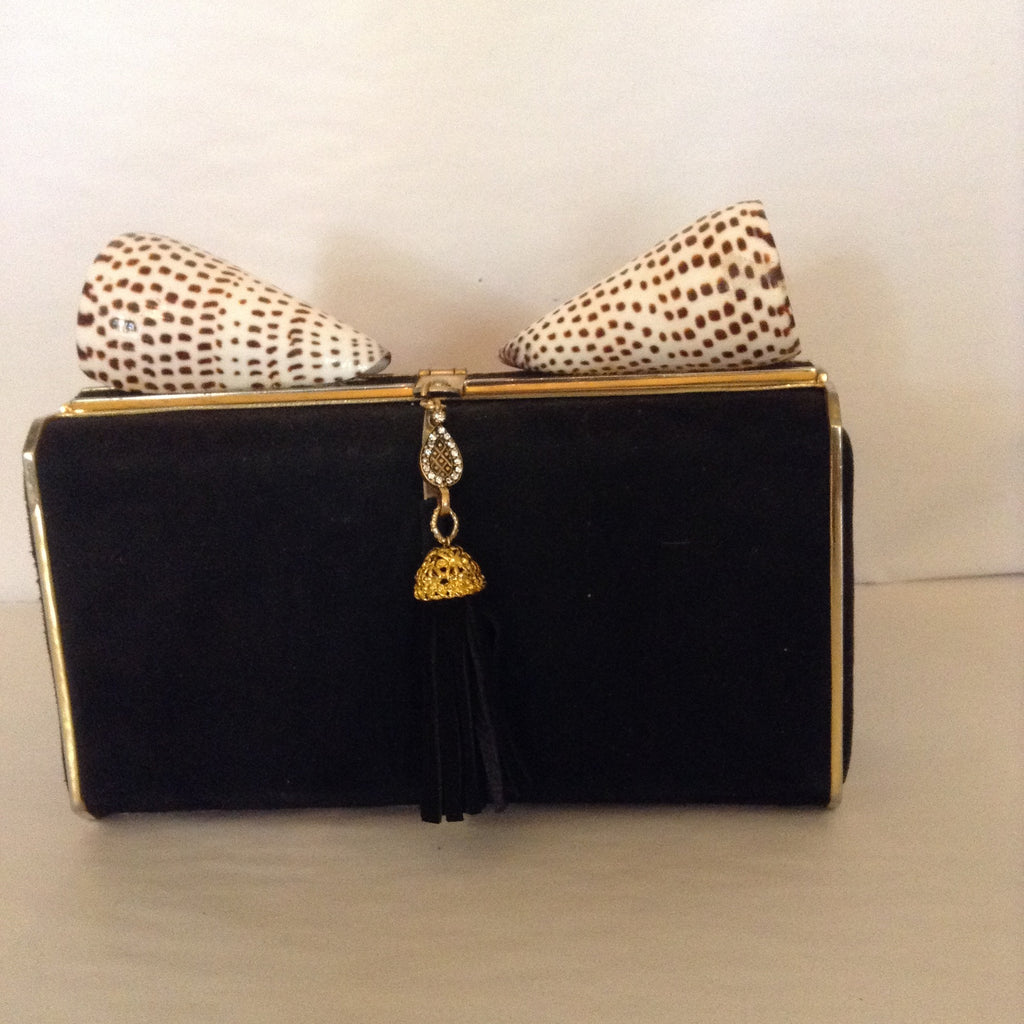 Sophisticated, yet whimsical. this black suede clutch with beaded tassel goes from day to night with its shell toppers.  Substantial, classy, easy to carry.  You're a diva in your little black dress with style that speaks softly but carries a big WOW!  Dimensions - Height 4 1/2"; Length 7 3/4"; Height 26"; Depth 2"