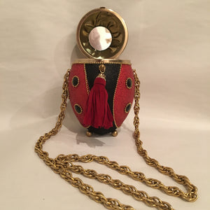 Sparkly red, black and gold metallic with crystals and beading in all the right places. She opens to reveal a mirror perfectly placed for checking your lipstick! Dimensions - 6" Height; 4" Width; Chain Length 17"