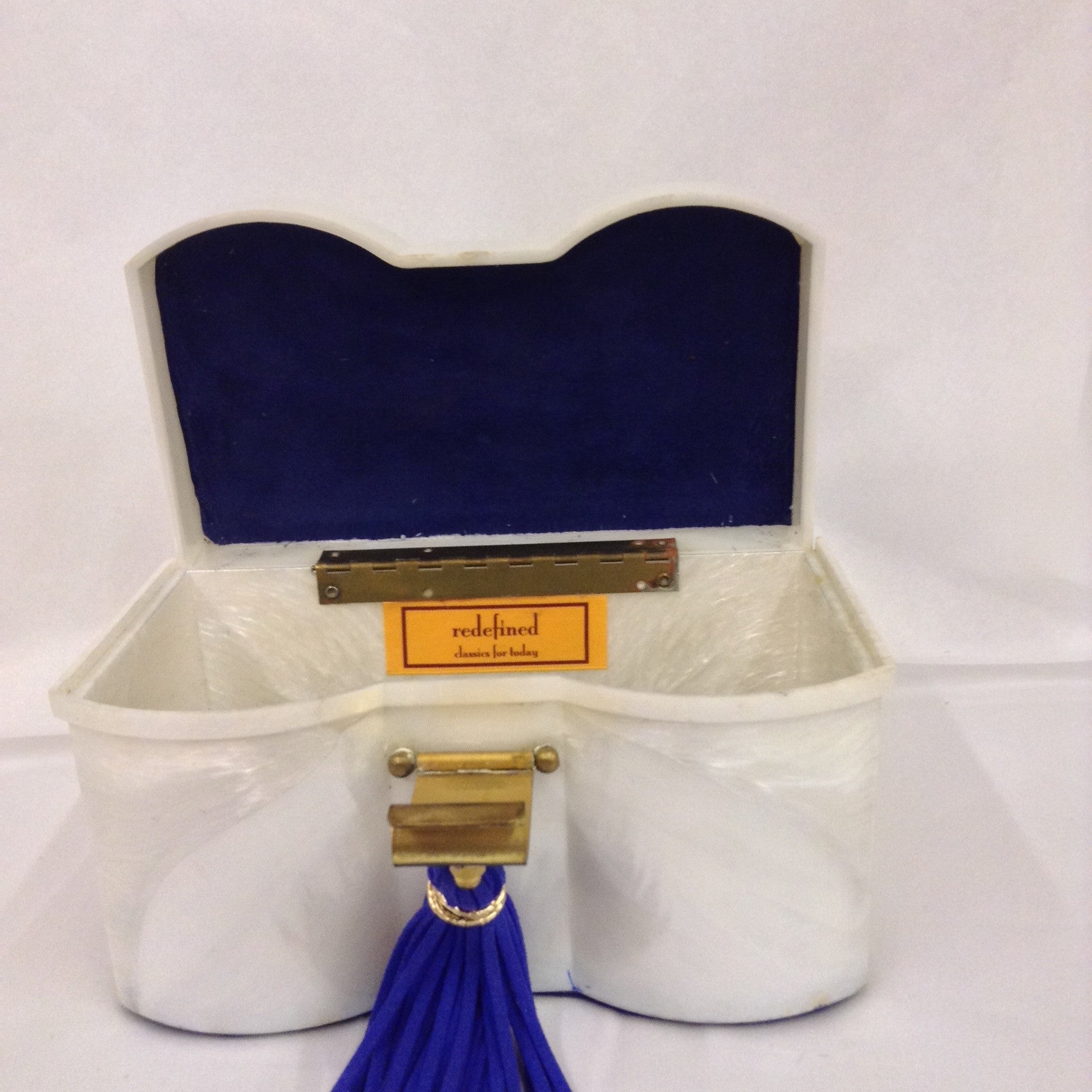 Unusual shape, color, hardware and vintage Maltese cross make this white lucite purse a necessity for your summer vacation to the Islands. White whites and blue blues with shiny brass accents complete the nautical theme of this fantastic classic.  Dimensions - Height 4"; Width 7 1/4"; Length 8 1/4"; Depth 4"
