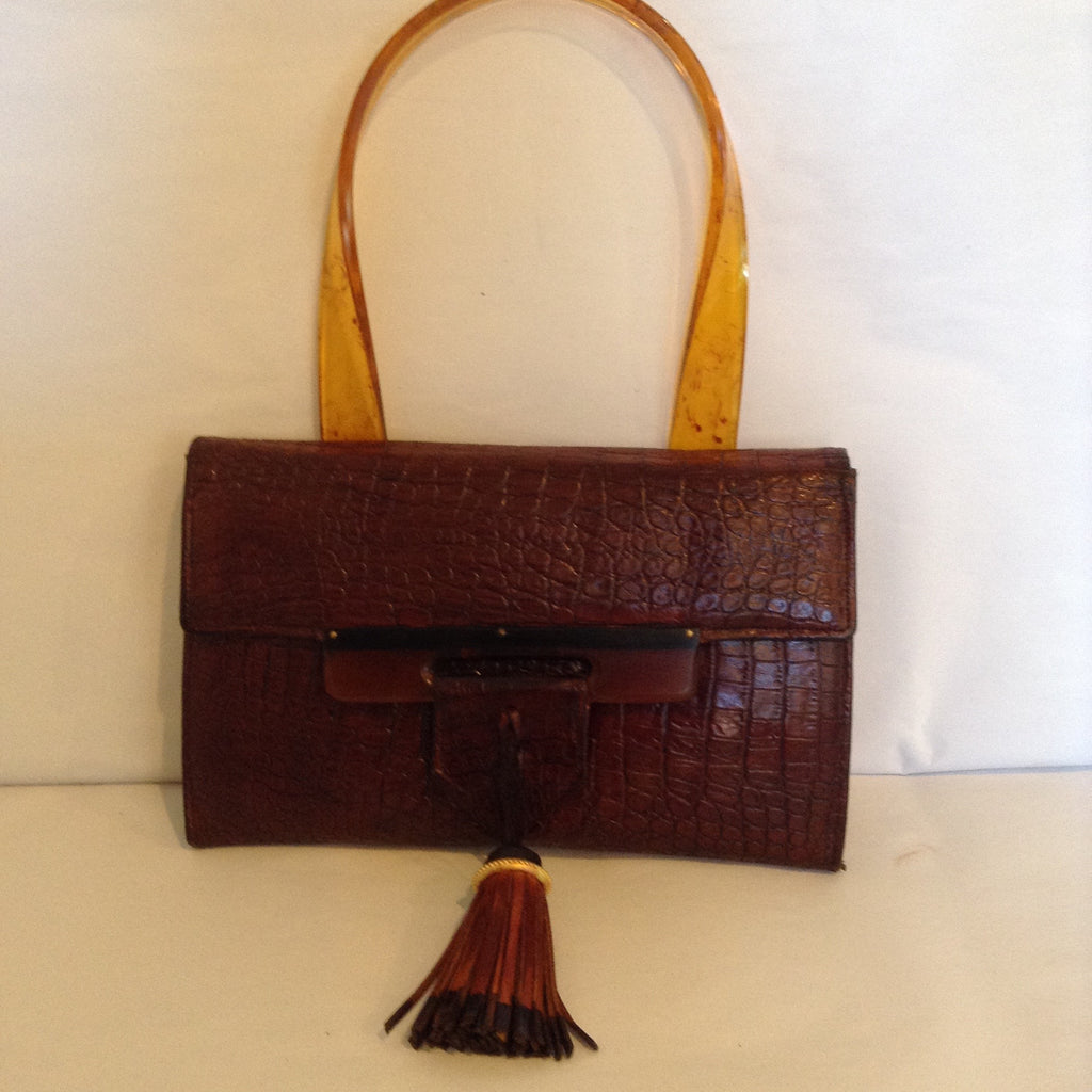 Brown Leather Lovely. Vintage brown leather purse with lovely lucite closure and handle.  Bi-colored black and brown tassel.  Slim and elegant.  Dimensions - Height 5 1/2"; Width 9"; Handle 6 1/2"; Depth 1"