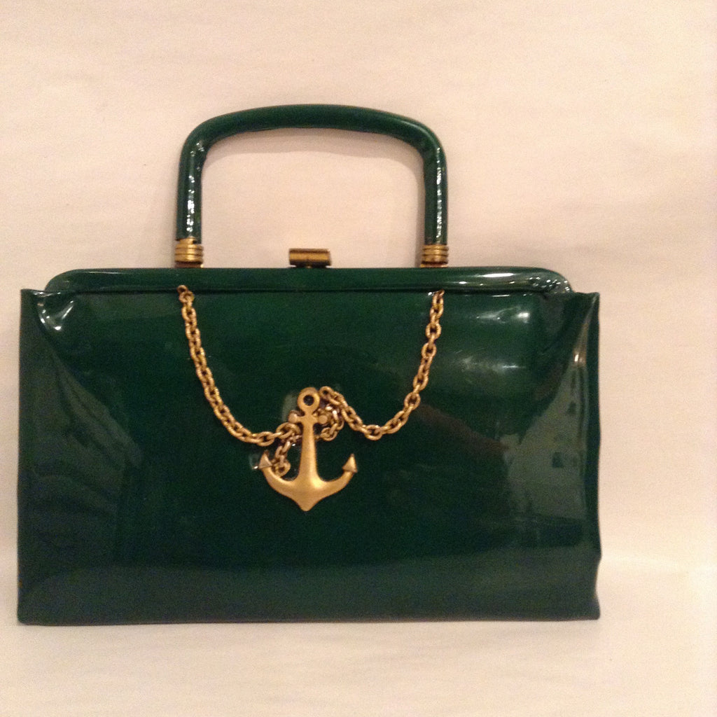 Fun little forest green patent leather with vintage fouled anchor and chain motif. The handle folds into the bag for use as a clutch.  Dimensions - Height 5 1/4"; Width 8 1/2"; Handle 2 1/2"; Depth 1 1/4"