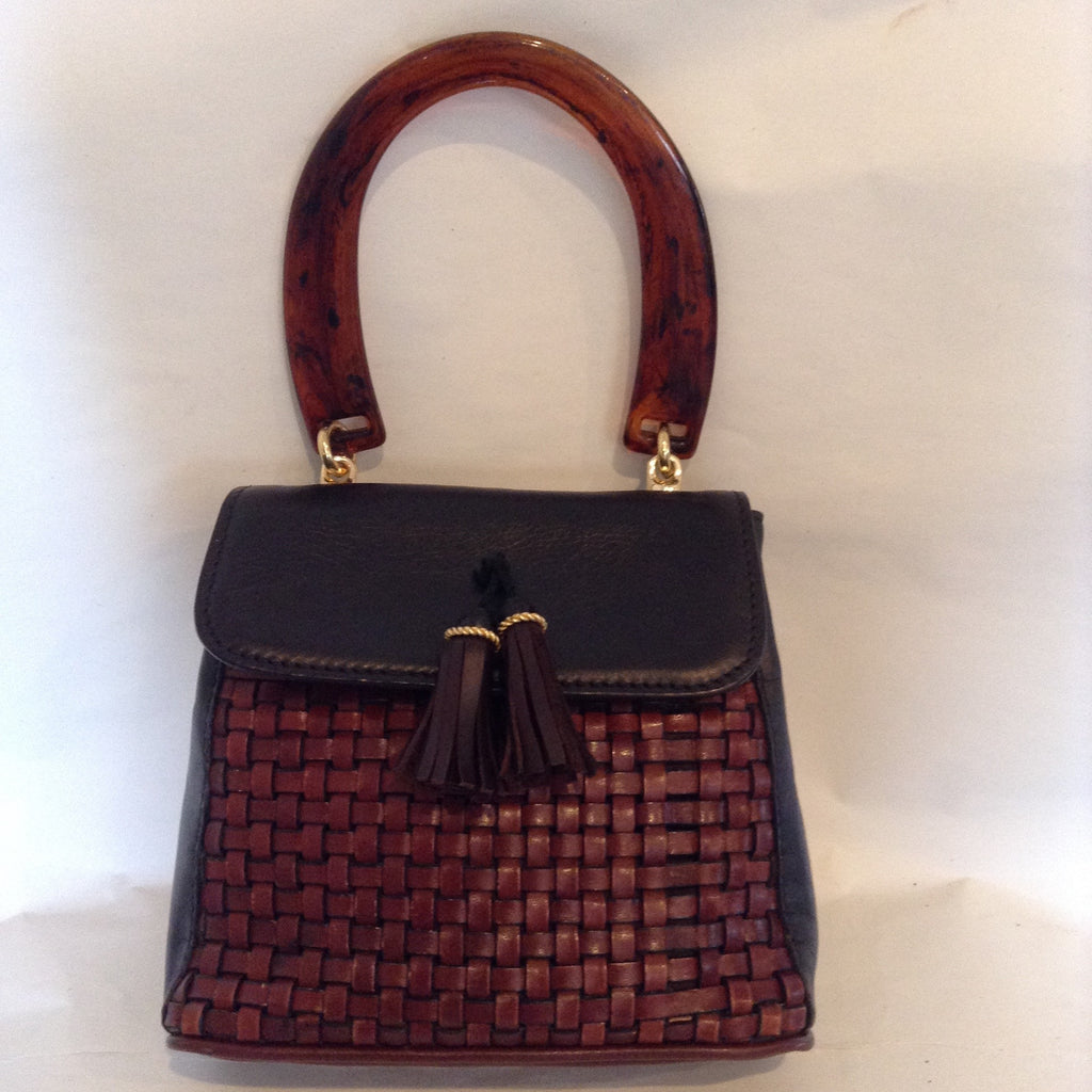 Vintage handbag woven leather in brown and black. Petite and playful, yet with just the right note of serious. Vintage tortoise brown lucite handle and lovely leather double tassel. Made in Canada from moose hide.  (Just kidding - it's soft and supple leather that you'll enjoy every day.)  Dimensions - Height 9"; Width 8"; Depth 4"; Handle 7"