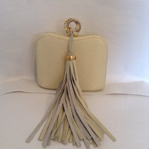 Delightful winter white leather vintage purse from the glamorous Rodo bag-maker of Italy.  The crystal-encrusted clasp and oversized suede tassel lend extra presence, and the tuck-in chain allows you to carry it as a clutch or shoulder bag.  Day or night, summer or winter, you will feel like a queen with this gorgeous bag.  Dimensions - Height 4 1/2"; Width 5 3/4"; Handle 23"; Depth 2 1/4"