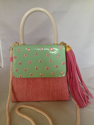 Faux croc in pink and sea-foam patent leather adorned with crystal beads and a pink suede tassel, this 60's bag has a new life with its striped silk lining and detachable cross-body cord.  Dimensions - 7" Height; 7.5" Width; 3" Depth; Handle 4"; Cord 22"