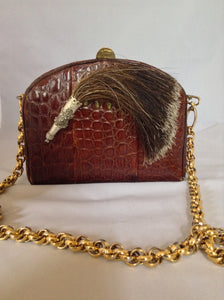 Beautiful brown South American vintage crocodile purse, a vintage Austrian hunting token, and a simple classic shape. The heavy chain detaches to be worn as a necklace or bracelet which looks and feels like 18K gold!  Dimensions - Height 5.5"; Length 7.5"; Width 3.5"; Chain 28"