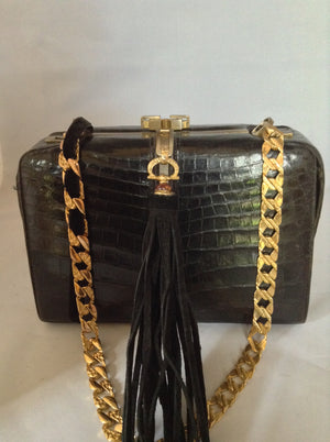 From one of the finest makers in Argentina, we found this beautiful black crocodile vintage purse in a couture shop in Buenos Aires (they did have other things of hers). But for sure you'll feel like Evita when you carry it!  Dimensions - Height 6"; Width 9"; Depth 5"; Chain 12"