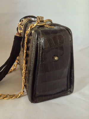 From one of the finest makers in Argentina, we found this beautiful black crocodile vintage purse in a couture shop in Buenos Aires (they did have other things of hers). But for sure you'll feel like Evita when you carry it!  Dimensions - Height 6"; Width 9"; Depth 5"; Chain 12"