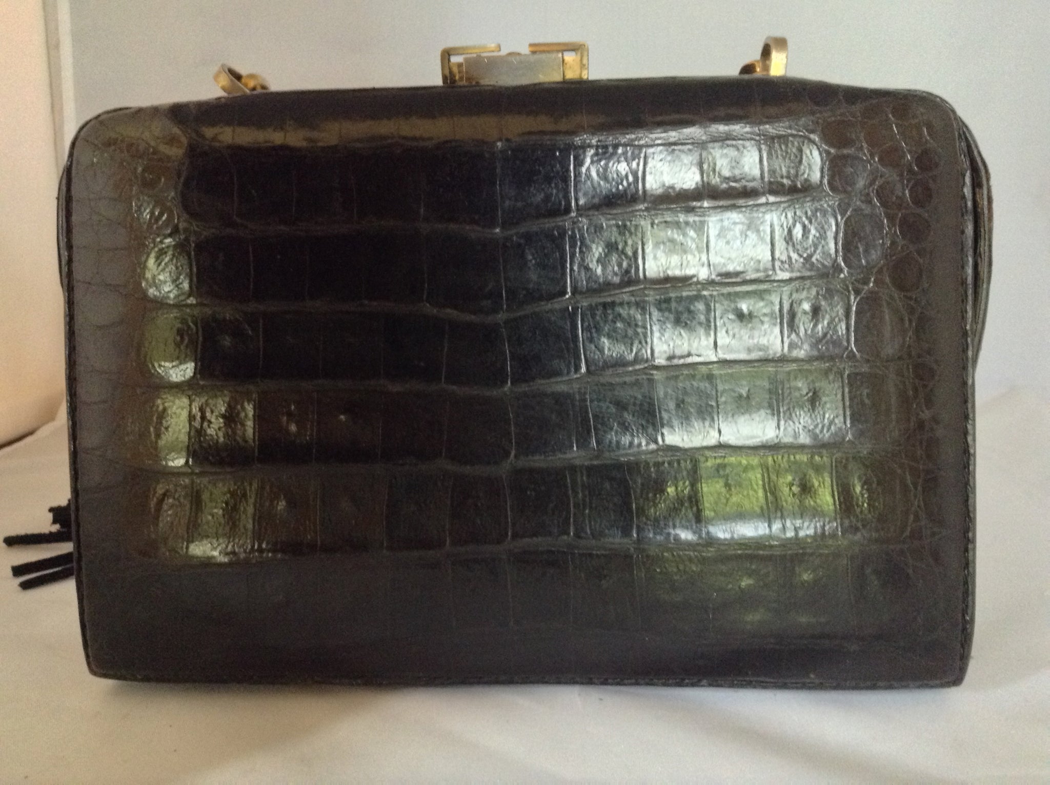 From one of the finest makers in Argentina, we found this beautiful black crocodile vintage purse in a couture shop in Buenos Aires (they did have other things of hers). But for sure you'll feel like Evita when you carry it!  Dimensions - Height 6"; Width 9"; Depth 5"; Chain 12"