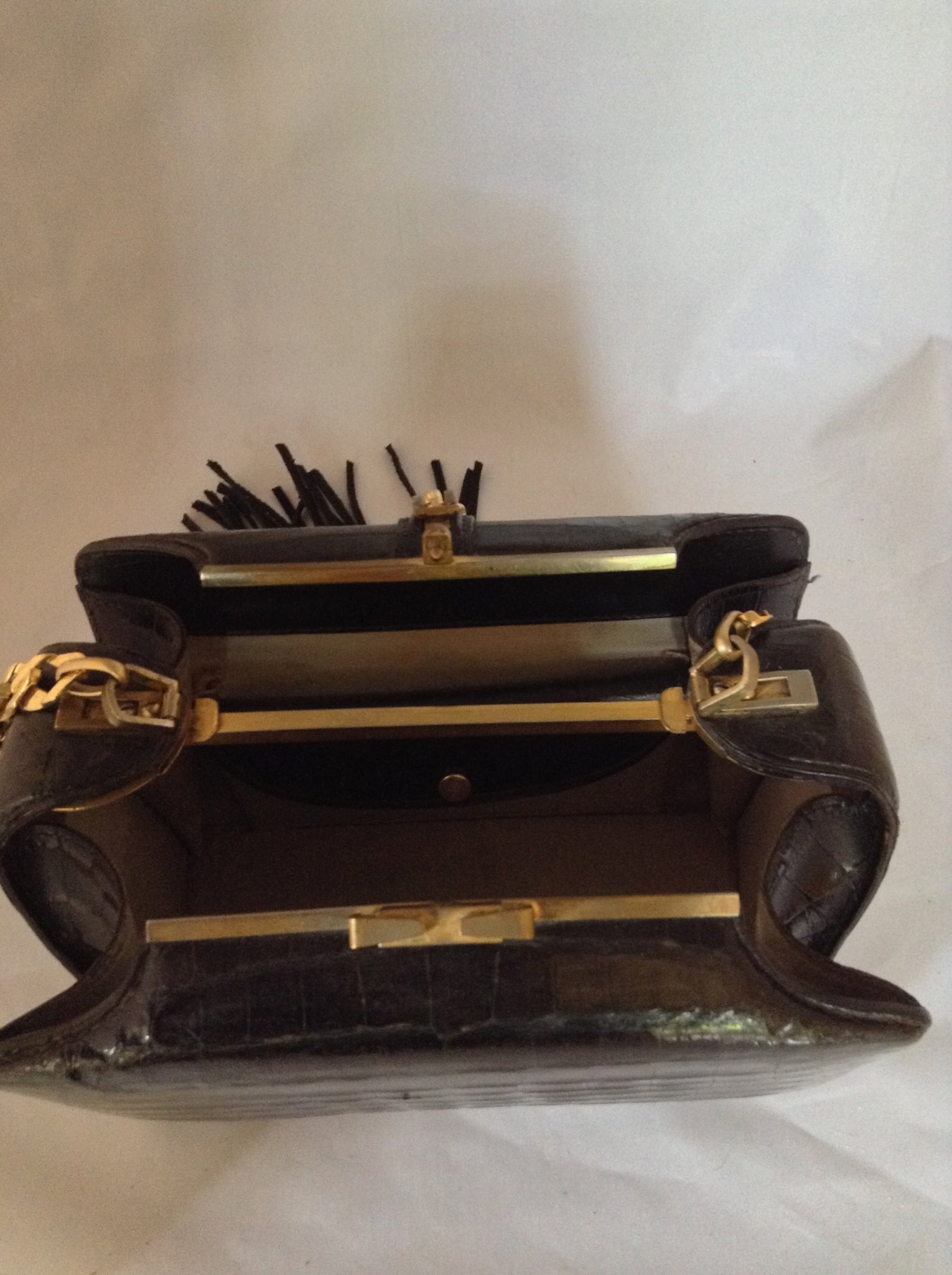 From one of the finest makers in Argentina, we found this beautiful black crocodile vintage purse in a couture shop in Buenos Aires (they did have other things of hers). But for sure you'll feel like Evita when you carry it!  Dimensions - Height 6"; Width 9"; Depth 5"; Chain 12"