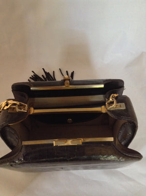 From one of the finest makers in Argentina, we found this beautiful black crocodile vintage purse in a couture shop in Buenos Aires (they did have other things of hers). But for sure you'll feel like Evita when you carry it!  Dimensions - Height 6"; Width 9"; Depth 5"; Chain 12"