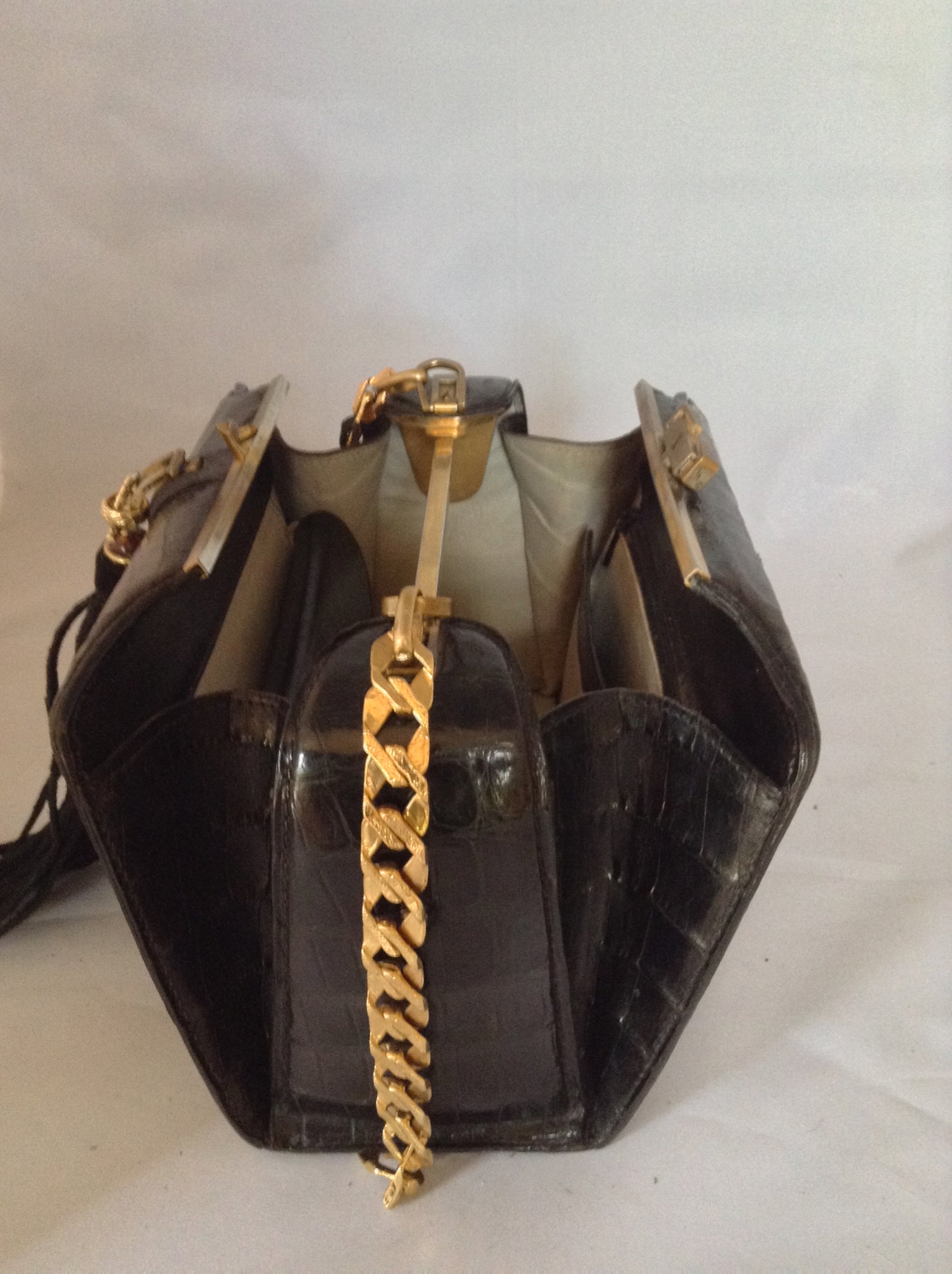From one of the finest makers in Argentina, we found this beautiful black crocodile vintage purse in a couture shop in Buenos Aires (they did have other things of hers). But for sure you'll feel like Evita when you carry it!  Dimensions - Height 6"; Width 9"; Depth 5"; Chain 12"