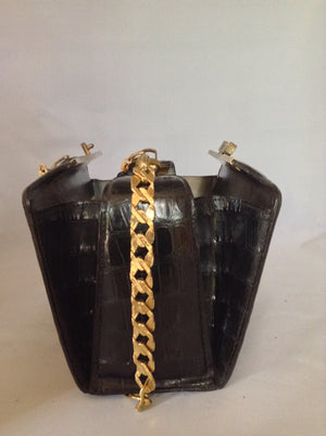 From one of the finest makers in Argentina, we found this beautiful black crocodile vintage purse in a couture shop in Buenos Aires (they did have other things of hers). But for sure you'll feel like Evita when you carry it!  Dimensions - Height 6"; Width 9"; Depth 5"; Chain 12"