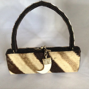 Long vintage purse with African zebra, snake and tiger skins... which ones are real and which are faux?   Only you will know for sure about the skins on this distinctive barrel-shaped handbag. (Ask us for the answer!). Includes a dangling tooth pendant with ornate antique silver top.