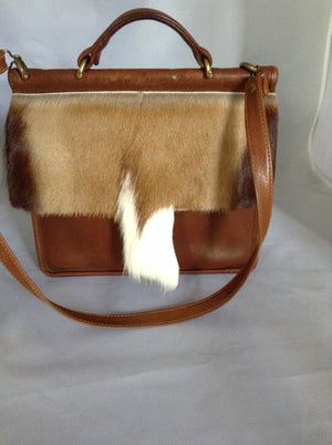 This original 1960's Coach bag has been updated with a silky soft antelope pelt. Your next business meeting will start with oohs and ahs as you take out your notebook and files.  Dimensions - Height 10"; Length 10"; Depth 3"