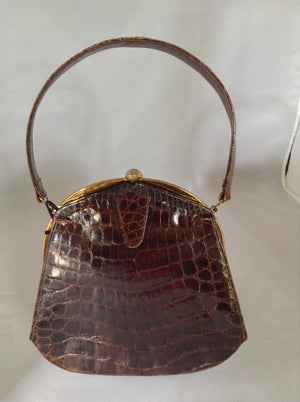 Vintage brown alligator purse by Deitsch who was an American maker of luxury reptile bags from the 1940's. It is so rare to find a pristine example that we added only a set of vintage tassels from the period (and we'll happily remove them for you purists out there!).  Dimensions - Height 8"; Length 8"; Width 2"