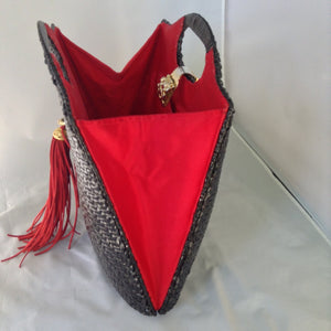 Super cool black straw vintage bag from Neiman Marcus. Red silk lining, over-sized suede tassel, wonderful hardware. Makes a statement. All you need is the right hat. A big one. Audrey would approve.  Dimensions - Height 14"; Width 14"; Depth 3"