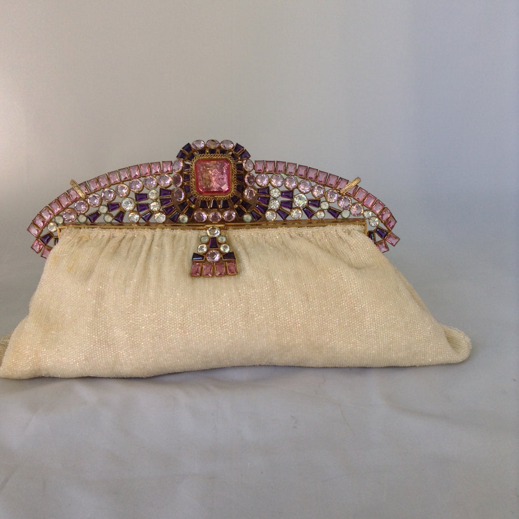 Vintage original cream beaded purse with a crown-like-handle adorned with pink, purple & white jewels, silk lining and a golden cross-body removable chain so you can gracefully toss those beads from your MardiGras float! Ooh-la-la! Magnificent, My Dear!  Dimensions - Height 6.5"; Length 9.5"; Depth 2"