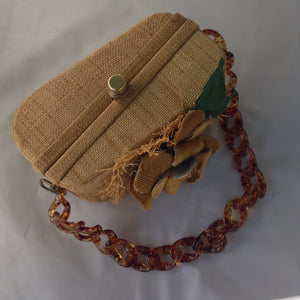 Vintage Straw & Raffia Box Bag with tortoise link handle, handmade flower and pristine silk lining? Ours is a 1950's original. His is from the Oscar de la Renta's Spring collection. His is $2000. Ours is a little less.  Dimensions - Height 4.5"; Length 8.25"; Depth 4.25"
