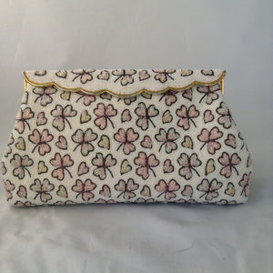 This vintage cream micro-beaded clover leaf clutch was made in France in the 1940s. It's covered with delicate light pink and green clovers and pink hearts too. Finally, it has a gold trim brass scalloped top that drapes over it's original vintage brass frame. They must not celebrate St. Patty in France because this gorgeous bag has never been used, but you'll carry it all Spring!  Dimensions - Height 5.5"; Length 9.5"; Depth 2"