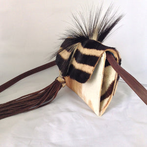 Cow plus zebra adds up to a fabulous cross-body/clutch with attitude! This adorable vintage purse is made from real cowhide and African zebra pelt with mane, suede lining, fabulous suede tassel, detachable leather cross-body strap. What more could a girl want?  Dimensions - Height 6"; Width 10"; Depth 2"