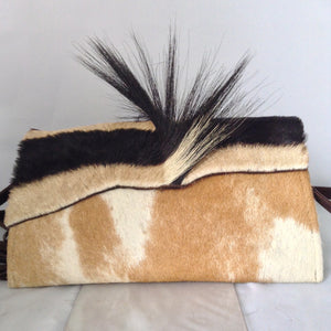 Cow plus zebra adds up to a fabulous cross-body/clutch with attitude! This adorable vintage purse is made from real cowhide and African zebra pelt with mane, suede lining, fabulous suede tassel, detachable leather cross-body strap. What more could a girl want?  Dimensions - Height 6"; Width 10"; Depth 2"