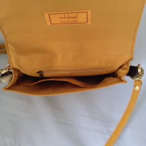 Charming "O" handle in vibrant mustard with accents of real zebra hide make for a darling vintage clutch. Add the detachable leather strap and voila - a cross-body charmer.  Dimensions - Height 6"; Width 8"; Depth 2"