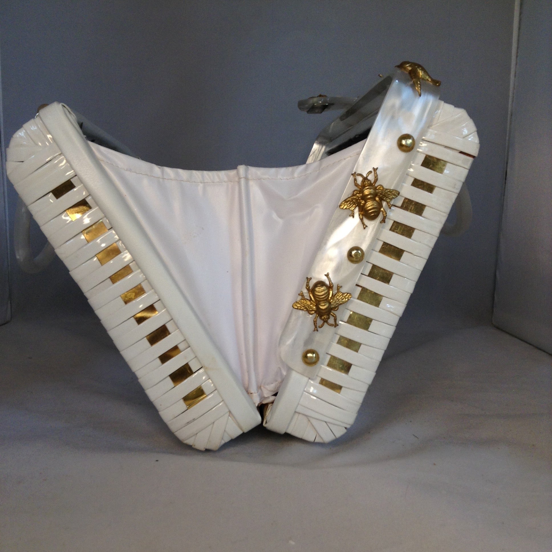Vintage White Shiny British Hong Kong Straw Purse With Golden Metal Weaving, Golden Birds and Bees. White Pearl Lucite Handles. Dimensions - Height 8.5"; Width 11.5"; Depth 3.5"; Handles 4"