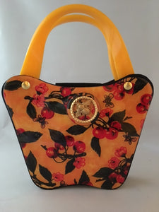 Bees love cherry blossoms, right? This little vintage yellow, black and red bag with its unusual curves is such a charmer.  Dimensions - Height 6"; Width 8"; Depth 3"; Handle 4"