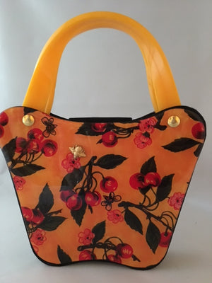 Bees love cherry blossoms, right? This little vintage yellow, black and red bag with its unusual curves is such a charmer.  Dimensions - Height 6"; Width 8"; Depth 3"; Handle 4"