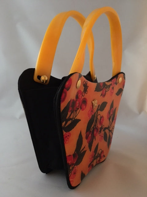 Bees love cherry blossoms, right? This little vintage yellow, black and red bag with its unusual curves is such a charmer.  Dimensions - Height 6"; Width 8"; Depth 3"; Handle 4"