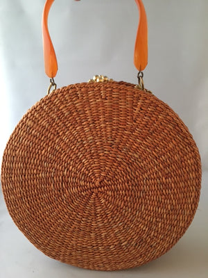 A great horned starfish and other wanna-bees encircle this unusual vintage straw bag. Leather lined with vintage lucite handle.You'll be in the inner circle wherever you take this!  Dimensions - Diameter 10"; Depth 4"; Handle 4"