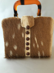 Would that be an Axis??? Square vintage handbag covered in baby deer pelt with an ostrich placket and tortoise buttons. What a combo!  Dimensions - Height 9"; Width 9"; Depth 3"; Handle 4"